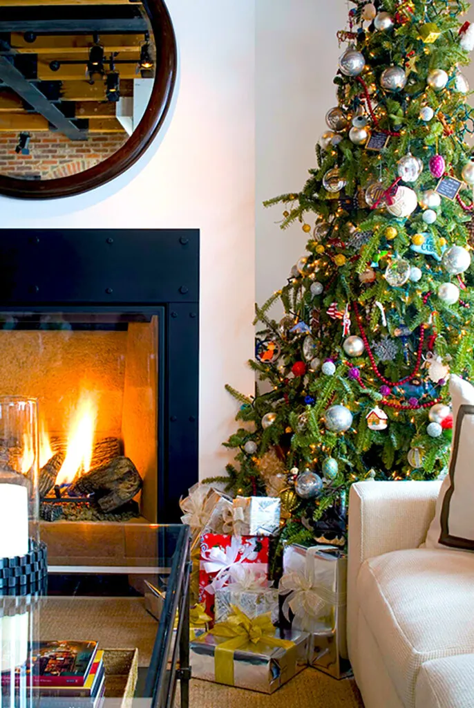 Photo of Christmas tree next to fireplace